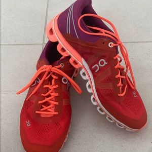Neon orange and purple oncloud running shoes